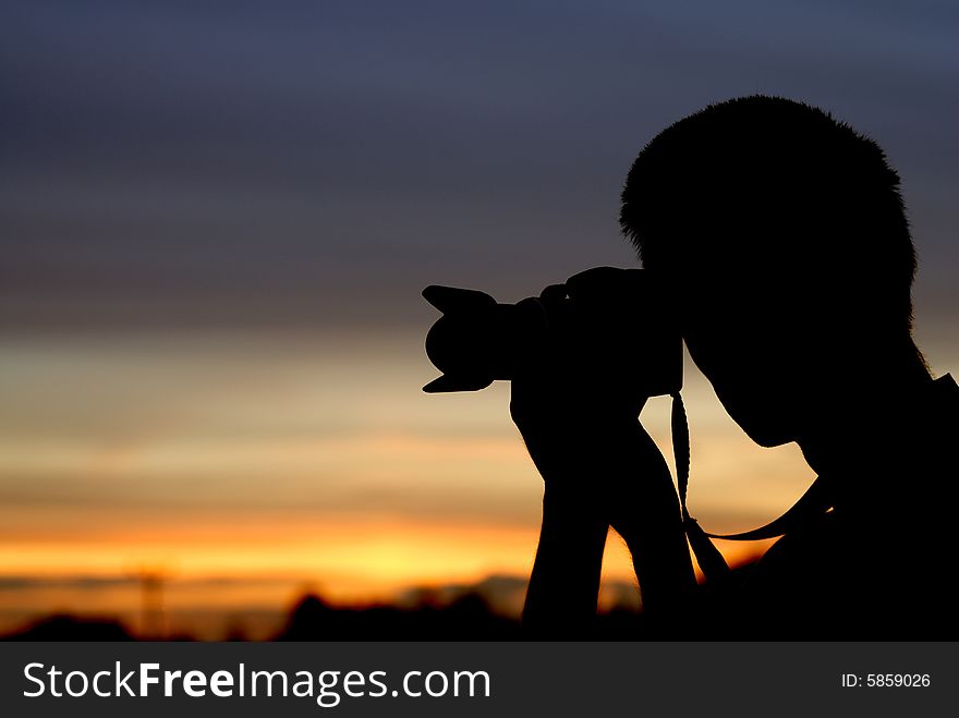 Photographer with sunset in the background. Photographer with sunset in the background