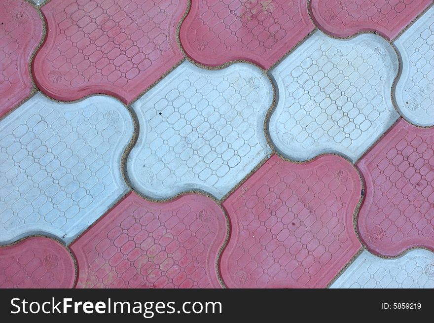 Close-up of new old-style pavement of figured stoneblocks (bricks) of red and light color