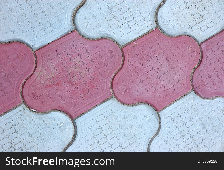 Close-up of new old-style pavement of figured stoneblocks (bricks) of red and light color