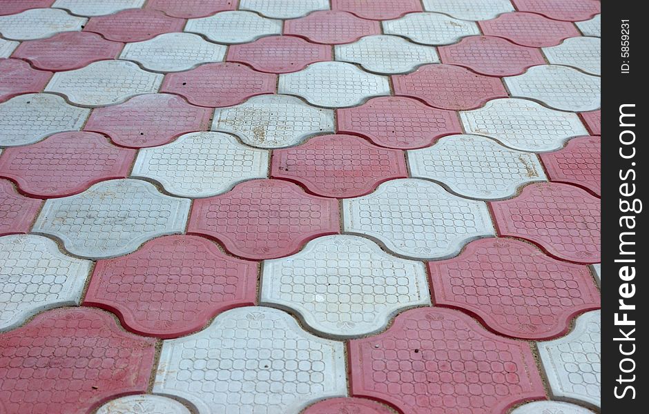 Close-up of new old-style pavement of figured stoneblocks (bricks) of red and light color