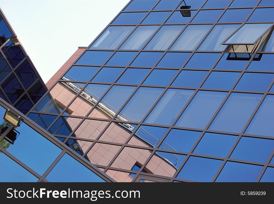 View of new modern office building of steel and glassagainst sky. View of new modern office building of steel and glassagainst sky