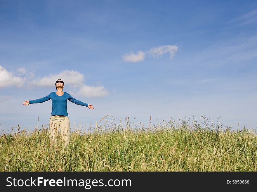 Attractive brunette woman relaxing on sky background. Attractive brunette woman relaxing on sky background