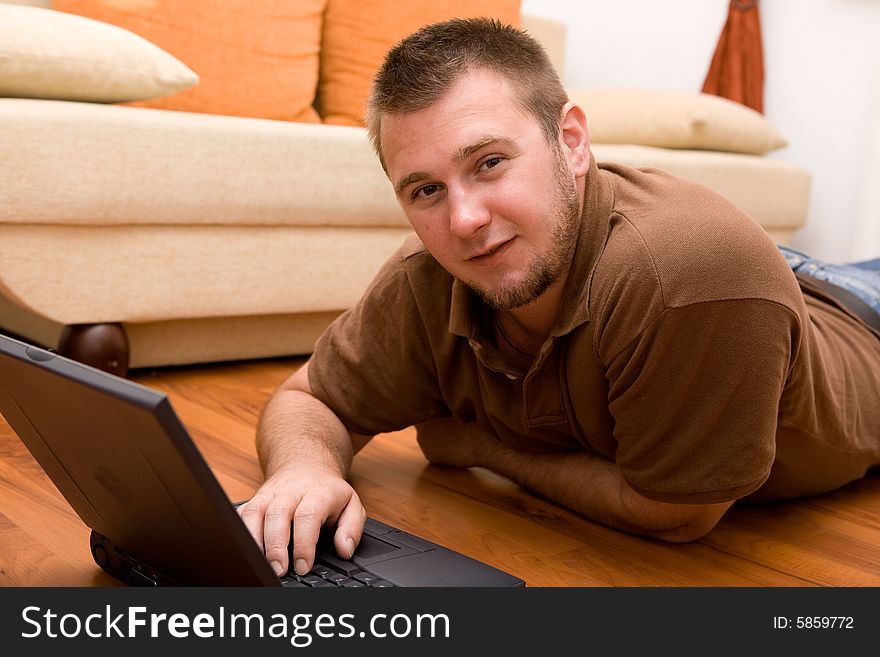 Happy man on sofa with laptop. Happy man on sofa with laptop