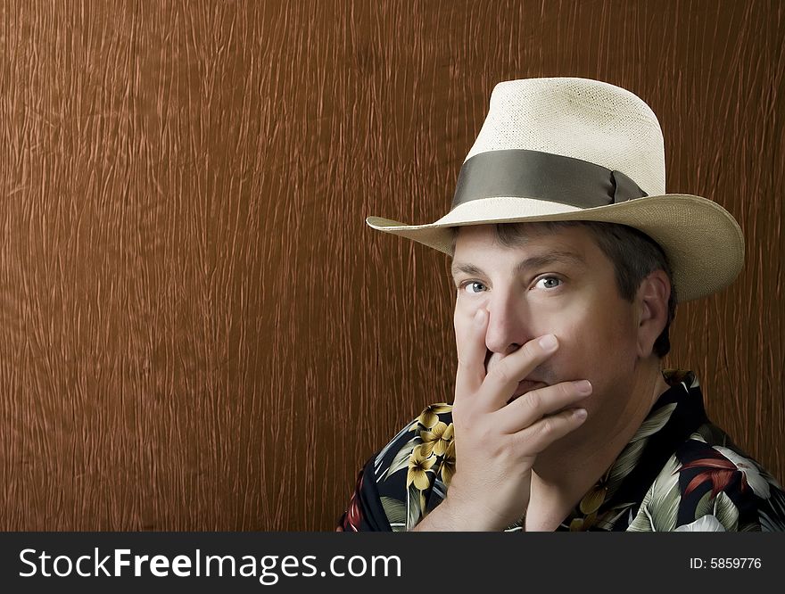 Portrait of a Man in a Flowerd Shirt with his Hand in Front of his face. Portrait of a Man in a Flowerd Shirt with his Hand in Front of his face