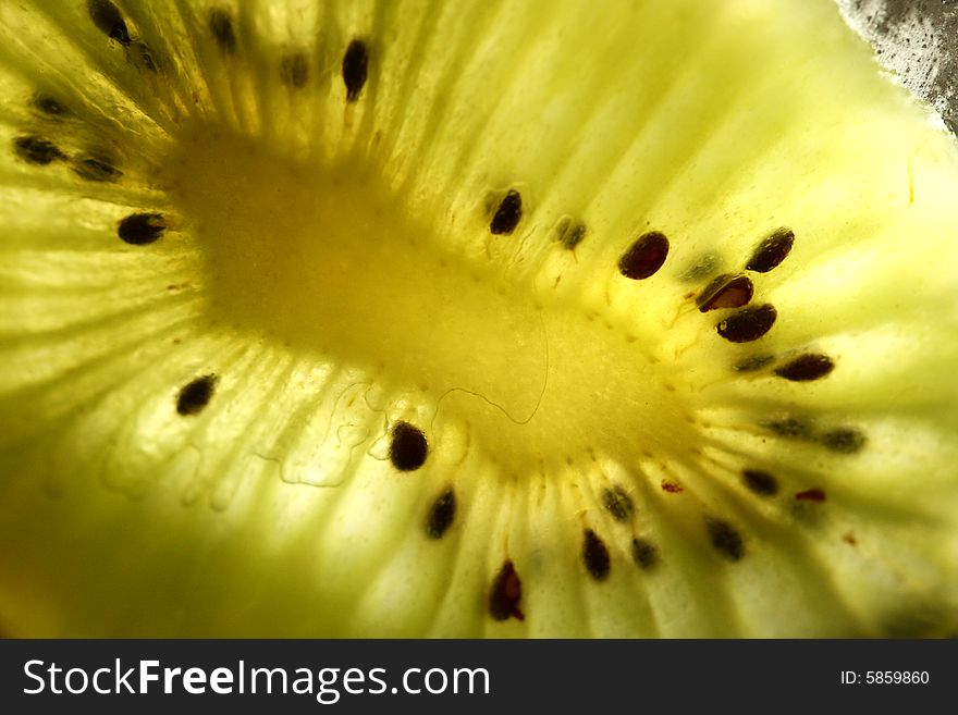 Close up of a kiwi sliced up with light through