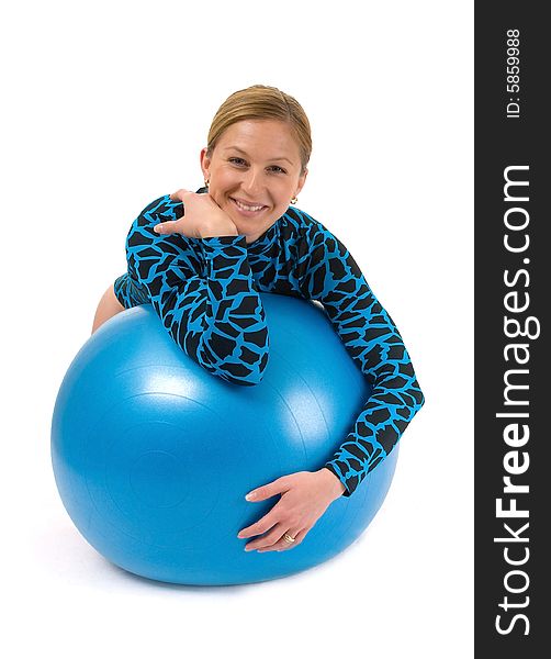 Girl leaning on a gym ball, smiling. Girl leaning on a gym ball, smiling