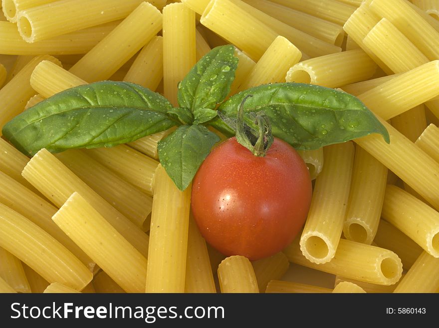 Photo of a fresh italian food ingredients with pasta tomato and basil