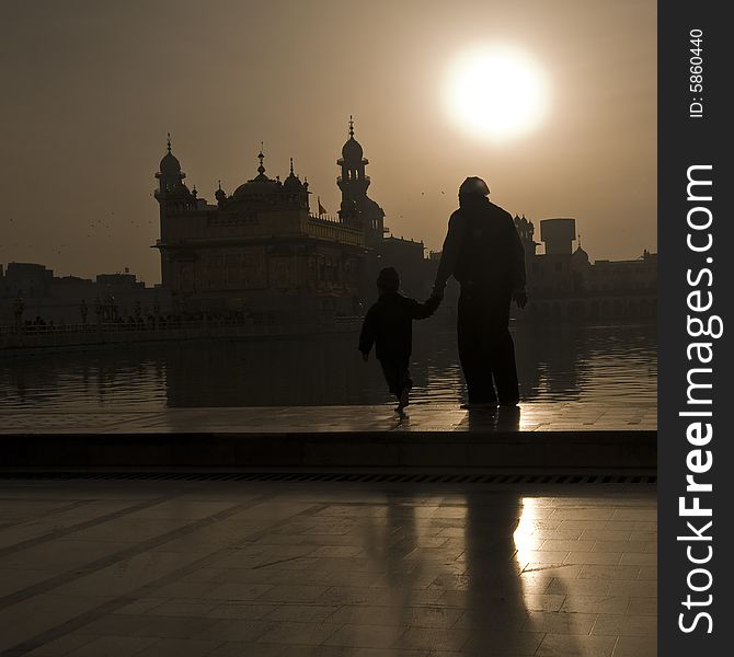Father ans son walking to Golden Temple, Sunrise. Father ans son walking to Golden Temple, Sunrise