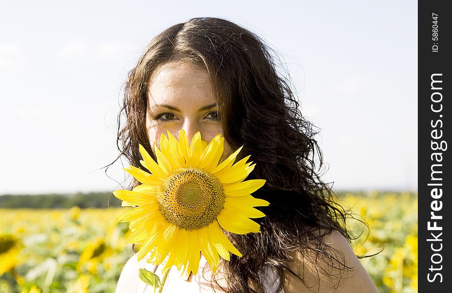 Portrait of young girl with sunflower