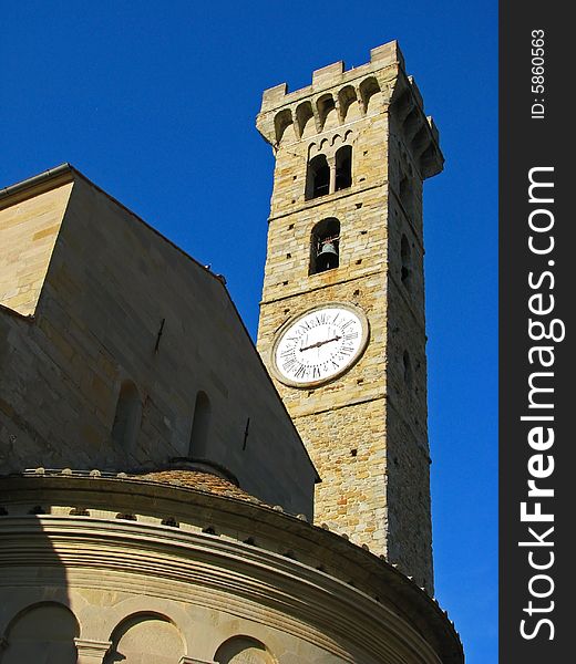 A medieval, renaissance bell and clock tower at the basilica in San Gimignano, Italy in Tuscany. A medieval, renaissance bell and clock tower at the basilica in San Gimignano, Italy in Tuscany.