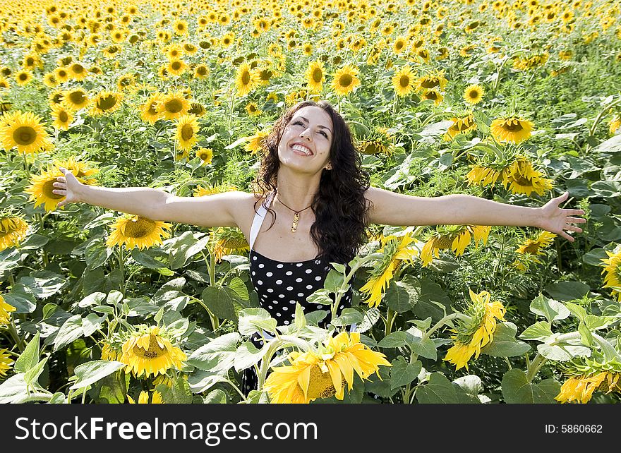 Happy girl in field of sunflowers