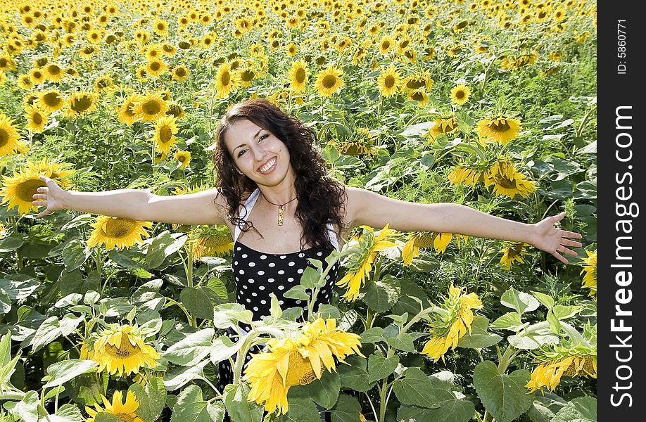 Happy girl in field of sunflowers