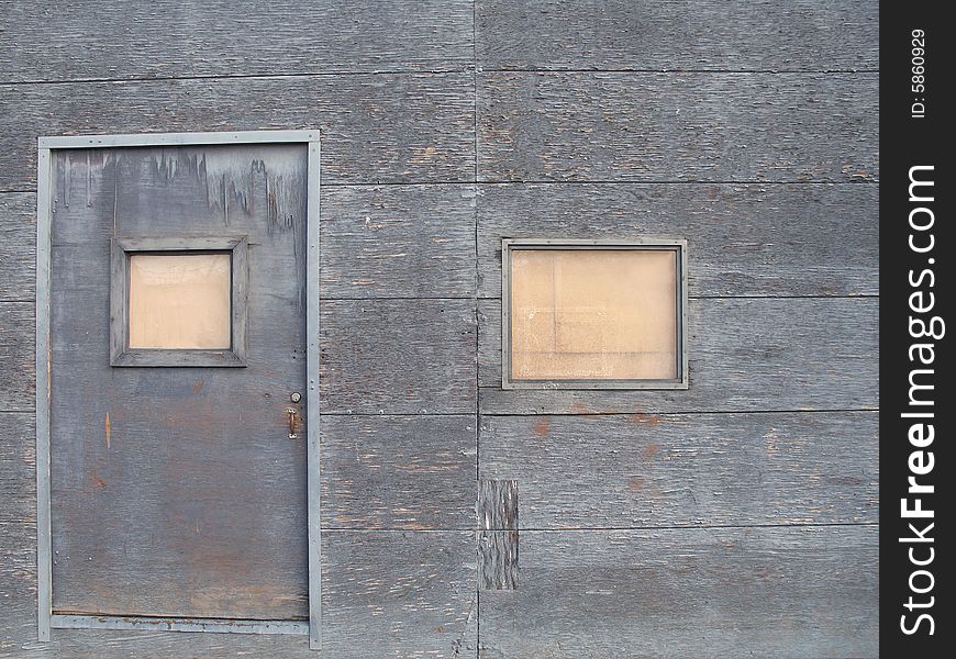 An old grey barricaded door