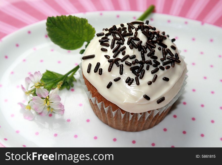 A birthday cupcake on a plate.