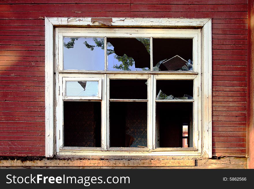 Dilapidated wooden building with a broken window. Dilapidated wooden building with a broken window