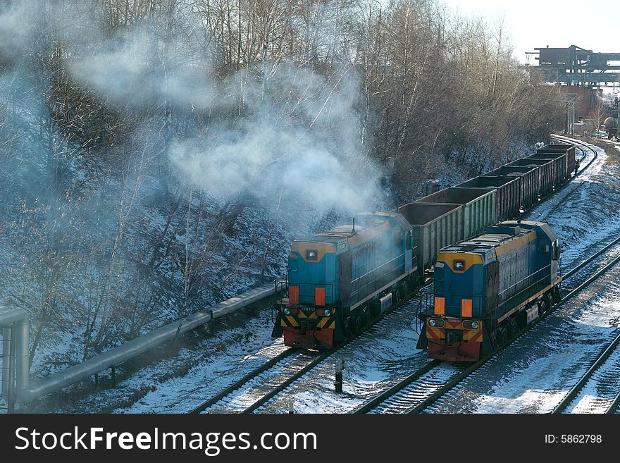 Train and diesel locomotive have a competition in velocities on railway in devil of the city Moscow. Train and diesel locomotive have a competition in velocities on railway in devil of the city Moscow