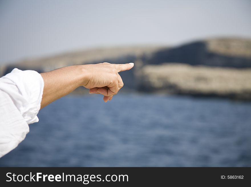 Finger showing a target on the sea