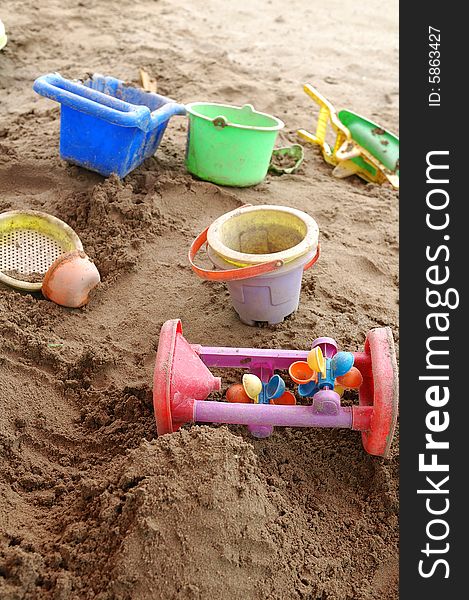 Children's toys in sand pool.