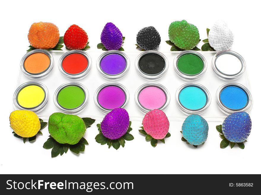 Colorful strawberry and eyeshadow on white background.