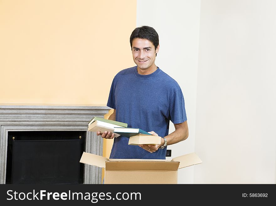 Young man holding cardboard boxes and smiling. Young man holding cardboard boxes and smiling