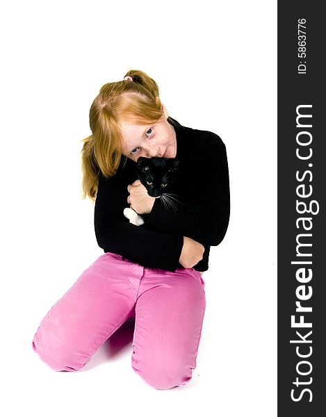 Girl is holding young kitten isolated