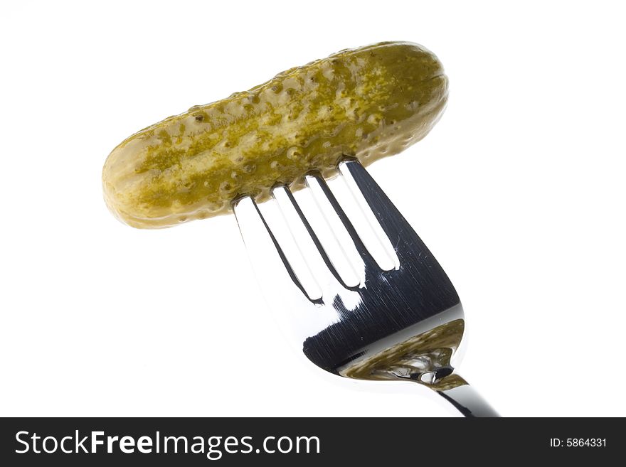 Crackling pickled gherkins on a plug on a white background