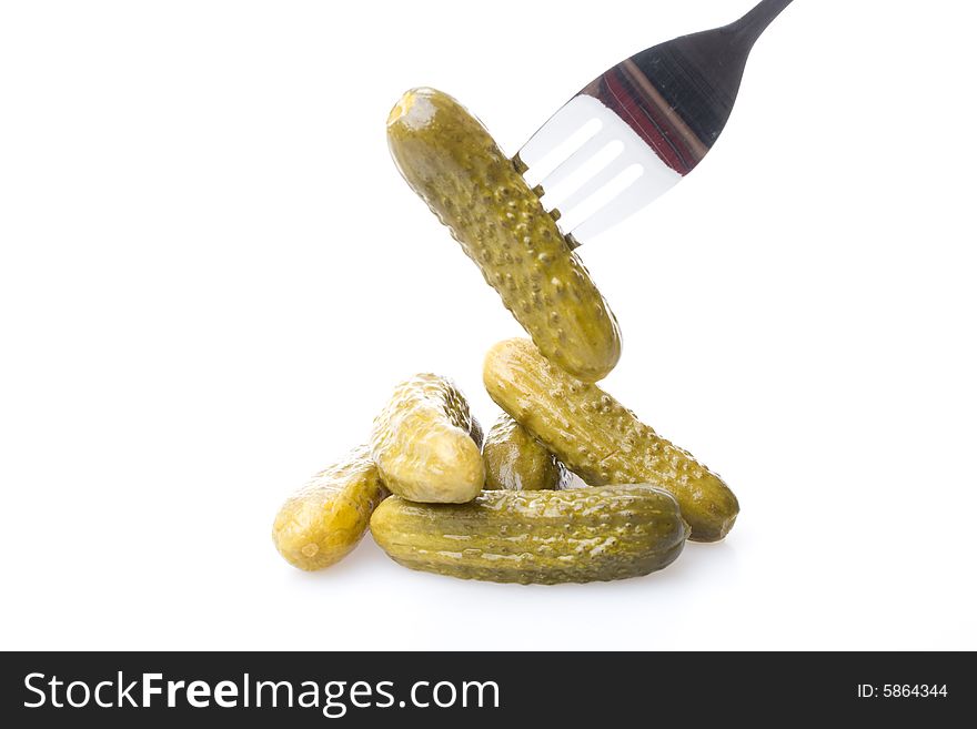 Crackling pickled gherkins on a plug on a white background