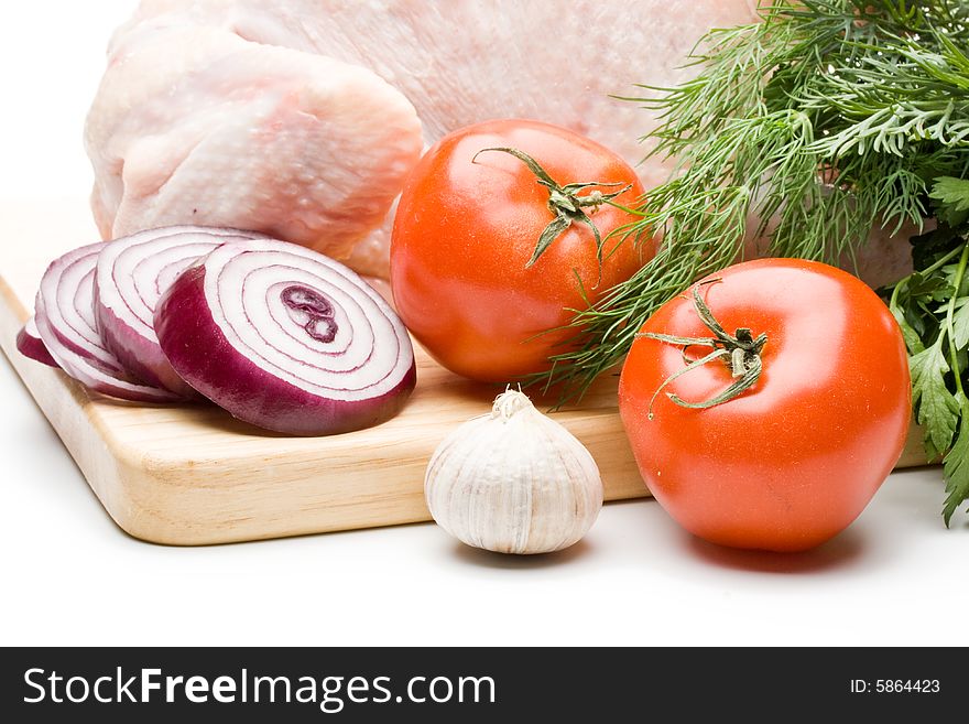 Fresh chicken with vegetables on a white background. Close up.