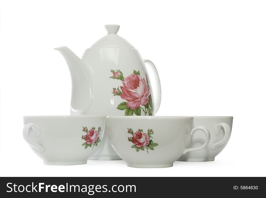 White tea set with flowers consisting of teapot and 3 teacups, isolated, with clipping path, on white background. White tea set with flowers consisting of teapot and 3 teacups, isolated, with clipping path, on white background