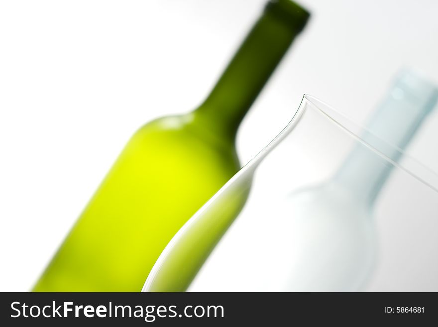 Close-up of white and green bottle with glass. Close-up of white and green bottle with glass