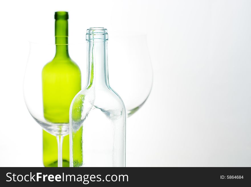 Close-up of white and green bottle with glass. Close-up of white and green bottle with glass