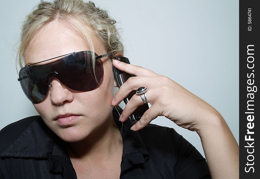 Girl with mobile phone and sunglass