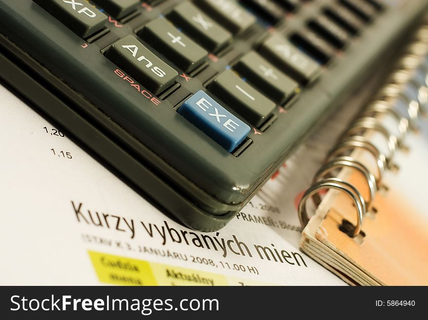 Calculator and notebook lying on a bursa charts. Calculator and notebook lying on a bursa charts