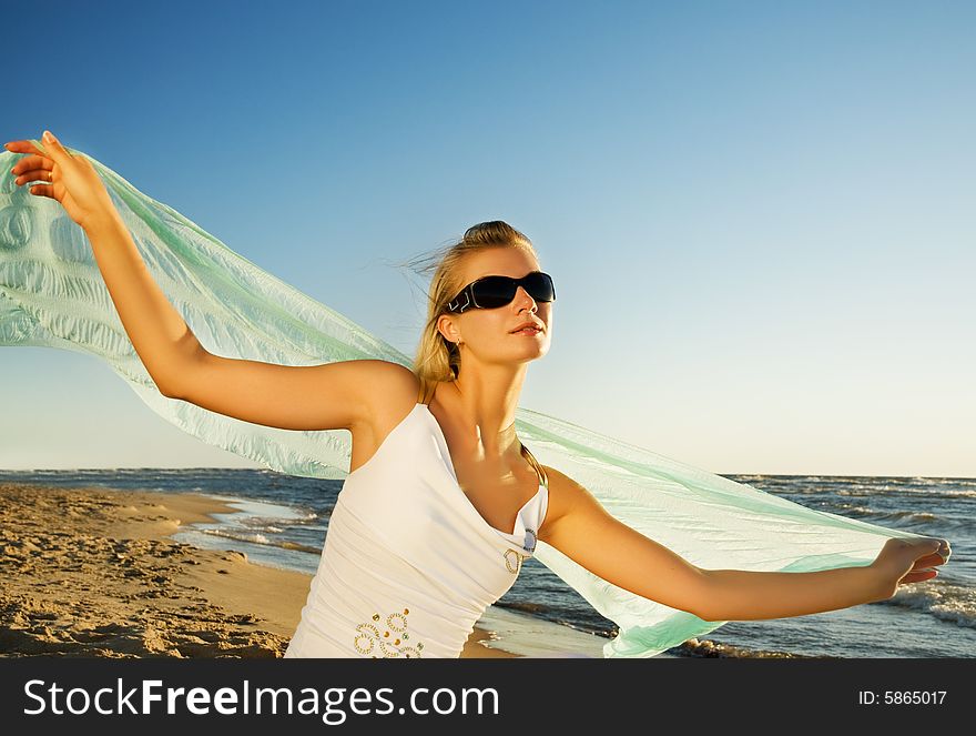 Beautiful young woman relaxing near the ocean