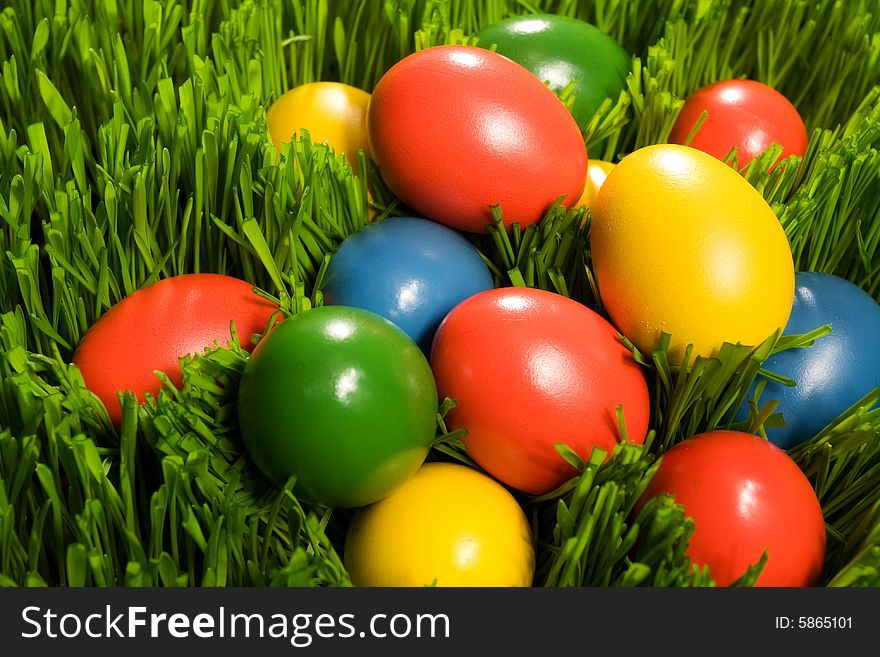 Yellow, red, blue and blue Easter Eggs in Grass