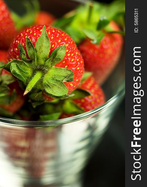 Strawberry in glass on black background. Strawberry in glass on black background