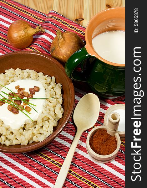 Traditional Slovak food - dumpling (halusky) with sheep cheese (bryndza) with bacon, chives, onion and Zincica