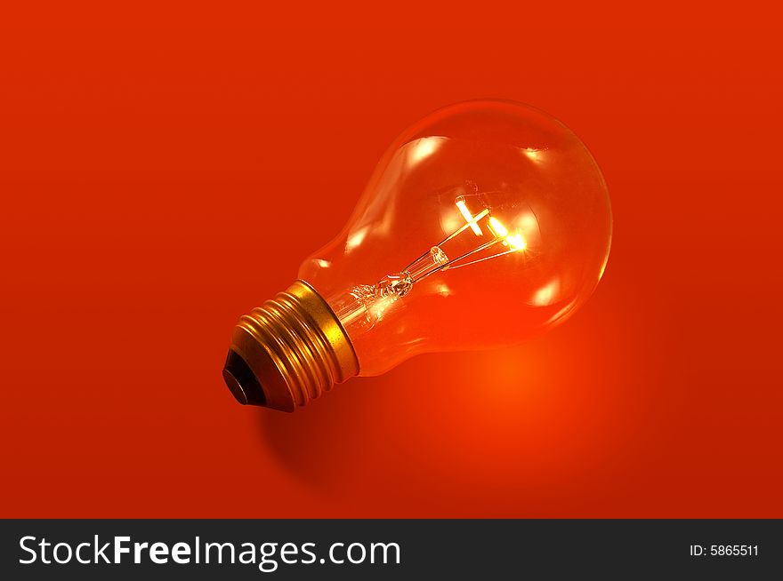 A bulb light on red background. A bulb light on red background