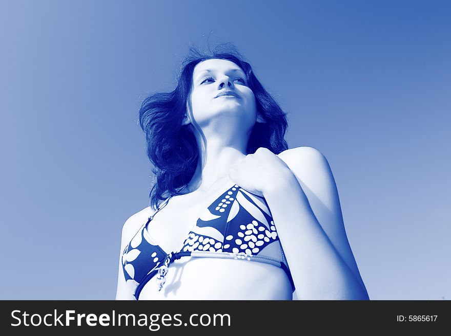 Woman in a bathing suit on a background of the blue sky