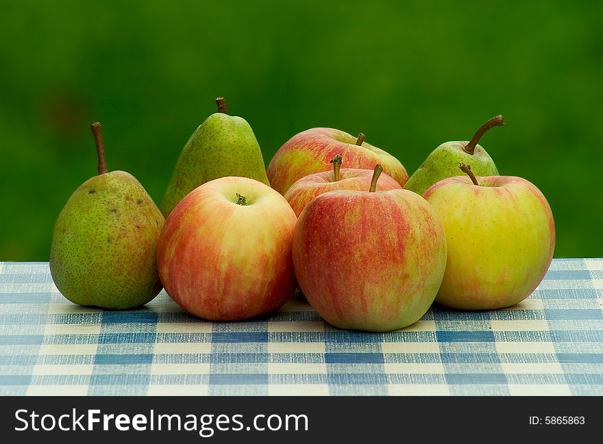Fresh green apples and pears on table-cloth. Fresh green apples and pears on table-cloth