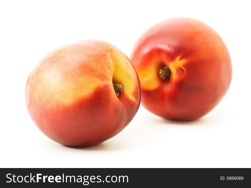 Two fresh ripe peaches over white. Shallow DOF