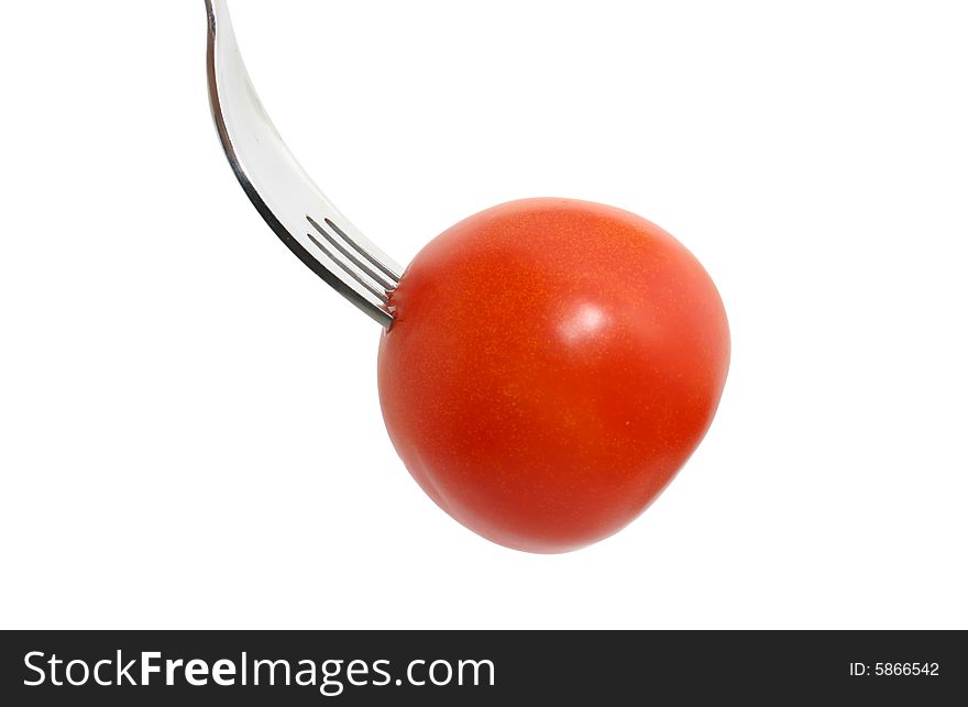 A tomato on a fork isolated on white