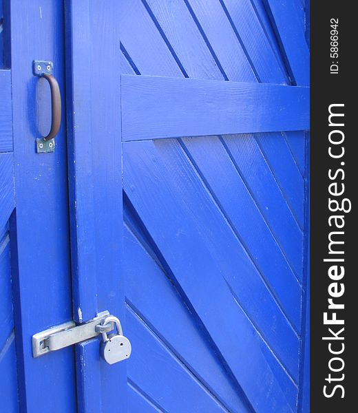 Blue, wooden, padlocked door in Key West