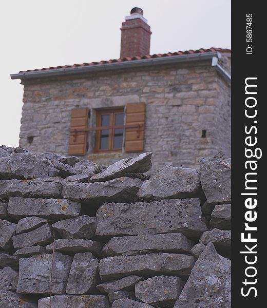 Countryside, rustic stone wall and house at dusk. Countryside, rustic stone wall and house at dusk
