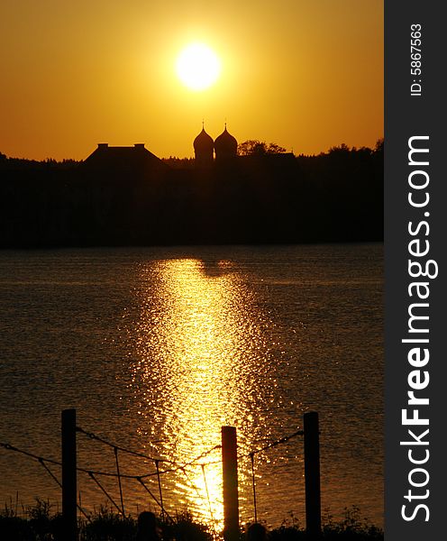 Evening sun above Old Monastery with Church on Seeon lake in  South Bavaria .  Not so far from Traunstein City and Chiemsee lake. Evening sun above Old Monastery with Church on Seeon lake in  South Bavaria .  Not so far from Traunstein City and Chiemsee lake.