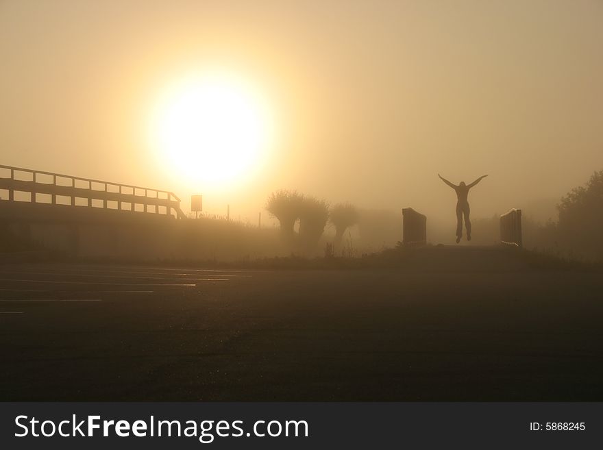 Morning jump on the bicycle bridge by a foggy field. Morning jump on the bicycle bridge by a foggy field