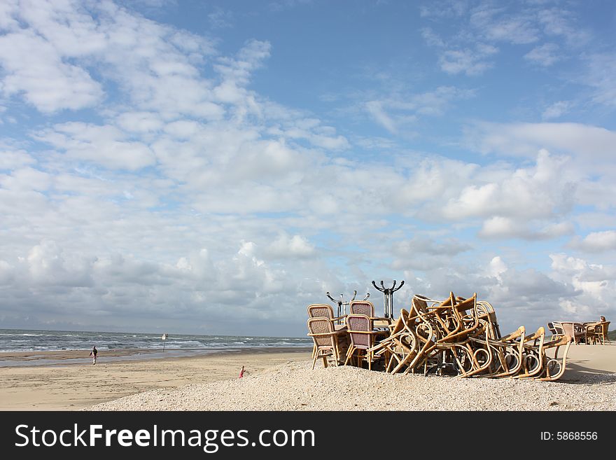 A stack of chairs on the beach. It looks like a Dali painting!. A stack of chairs on the beach. It looks like a Dali painting!