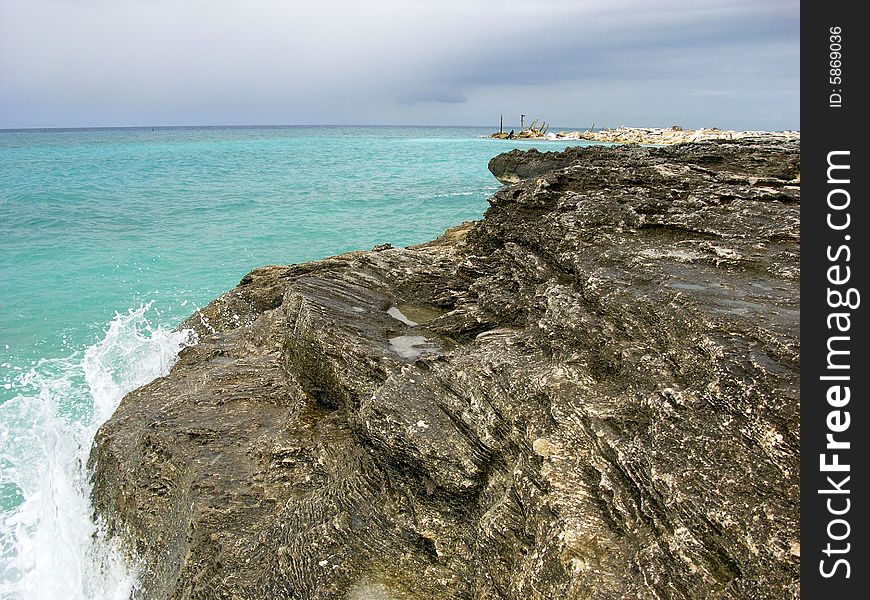 The rocky hostile coastline in Freeport on Grand Bahama Island, The Bahamas. The rocky hostile coastline in Freeport on Grand Bahama Island, The Bahamas.