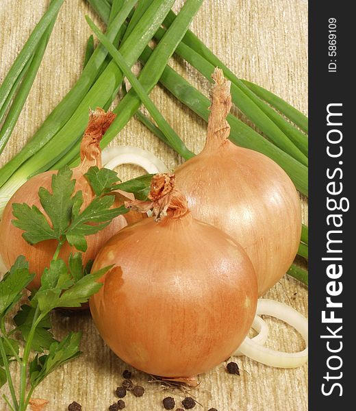 Three bulbs with a parsley on a green onions and a sacking