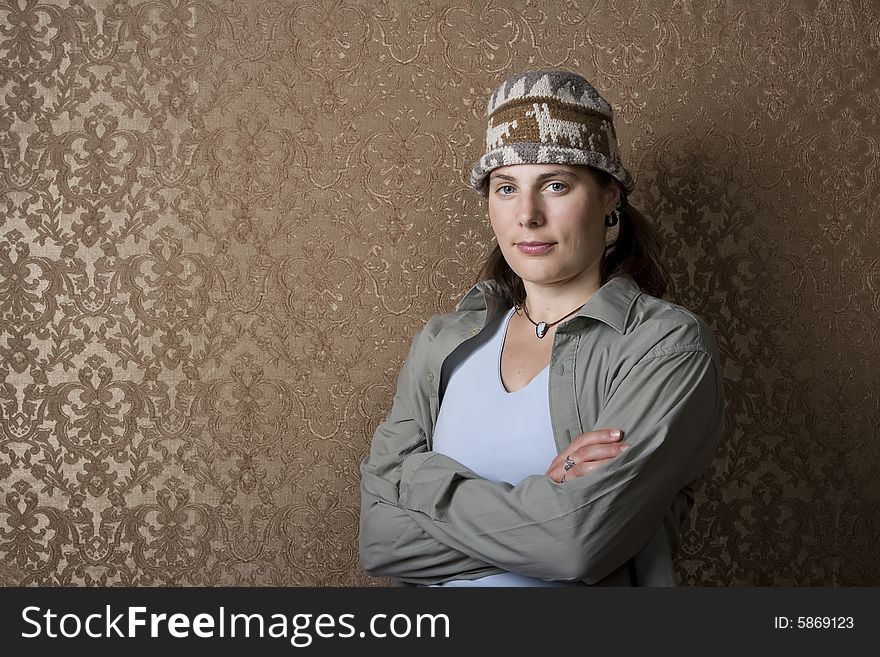 Pretty young woman in front of gold wallpaper